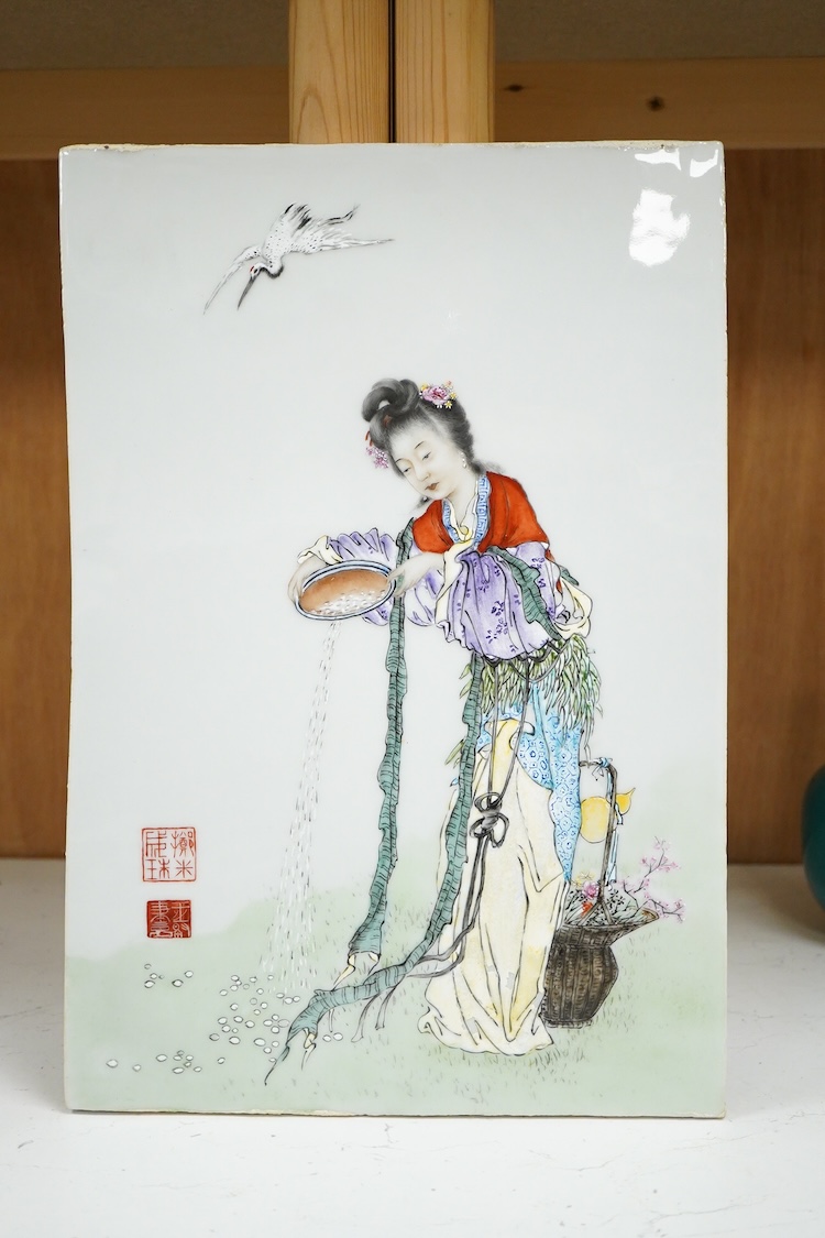 A Chinese famille rose porcelain plaque depicting a woman feeding birds, 36cm high